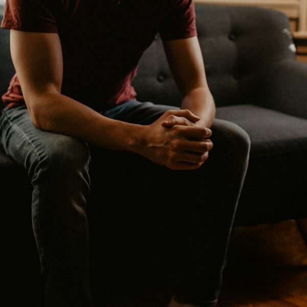 Should I go to therapy? man sitting on sofa