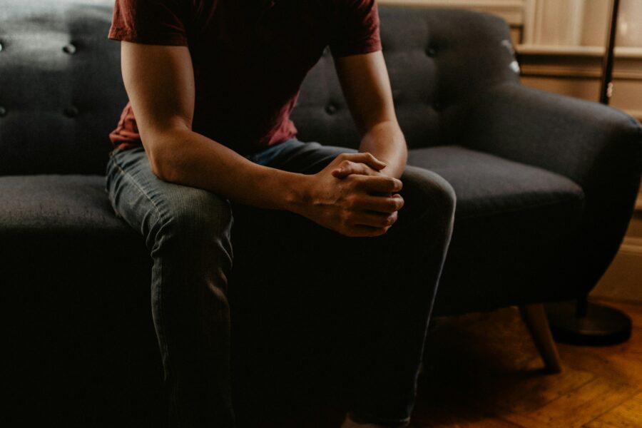 Should I go to therapy? man sitting on sofa